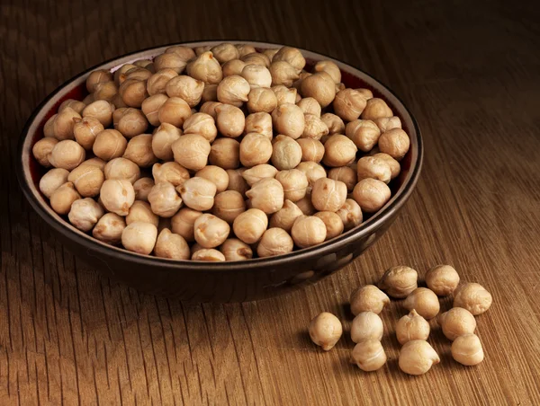 Chickpea on plate on wooden — Stock Photo, Image