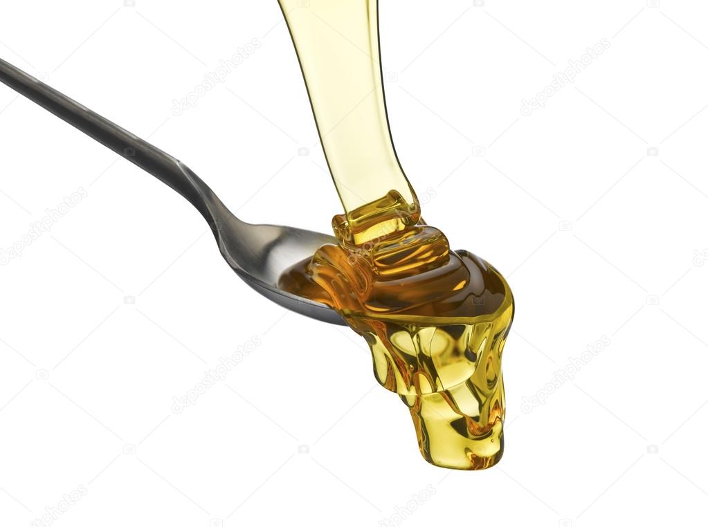 spoon of honey over white