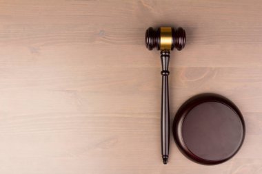 Brown wooden judges gavel on the table in close up. Wooden table. Space for text. Law and Justice theme clipart