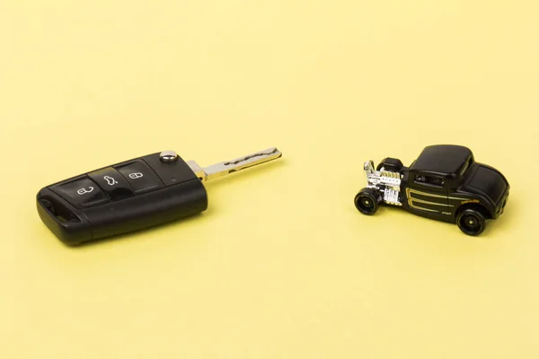 Black toy car and key. Concept of the automobile loan, saving money for car, trade car for cash, the concept of Finance.