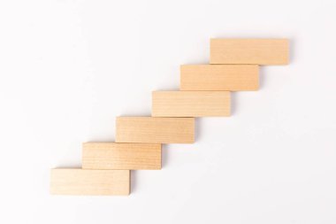 Beyaz arka planda tahta blokları olan merdivenler. Kariyer tanıtımı konsepti