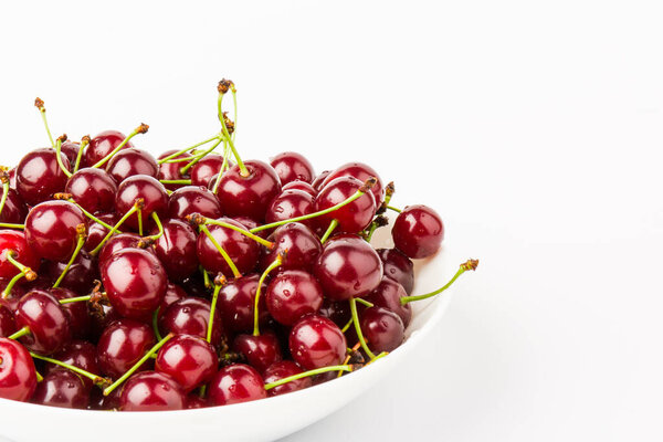 fresh and sweet red cherry fruit in plate isolated on white background