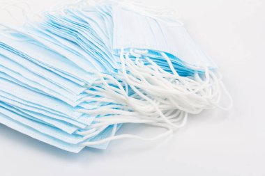 Mavi tıbbi maske beyaz arka planda izole edilmiş. Kirliliğe, virüse, gribe ve koronavirüse karşı yüz maskesi koruması. Sağlık ve Cerrahi Konsept.