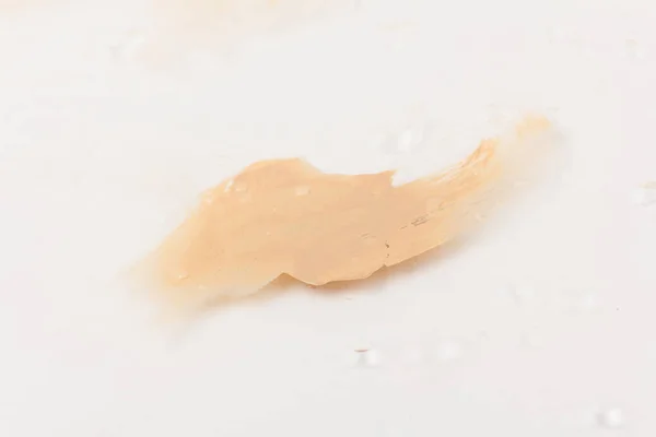 liquid foundation paint strokes isolated on white. Cosmetic makeup foundation isolated on white background, tone cream smudged, concealer. Smear stroke.