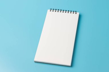 Mavi arkaplanda açık spiral boş defterin üst görünümü 
