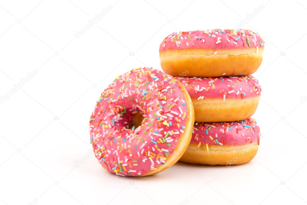 Donuts with strawberry icing and multicolored sprinkles, isolated on a white background. Traditional sweet pastries. Place for text.