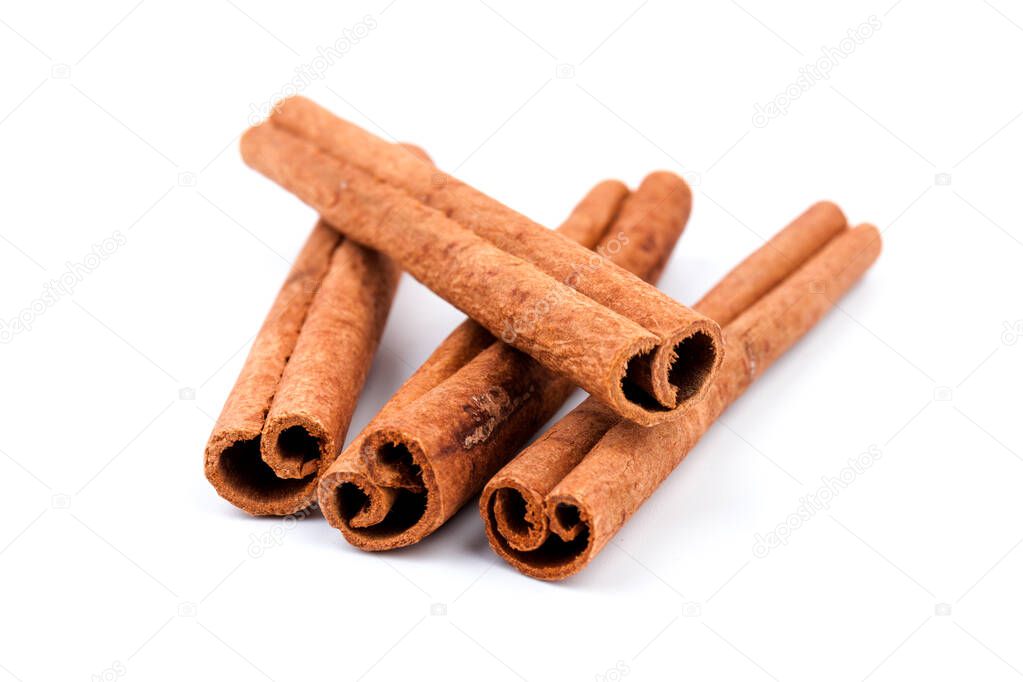 Aromatic dry cinnamon sticks on white background