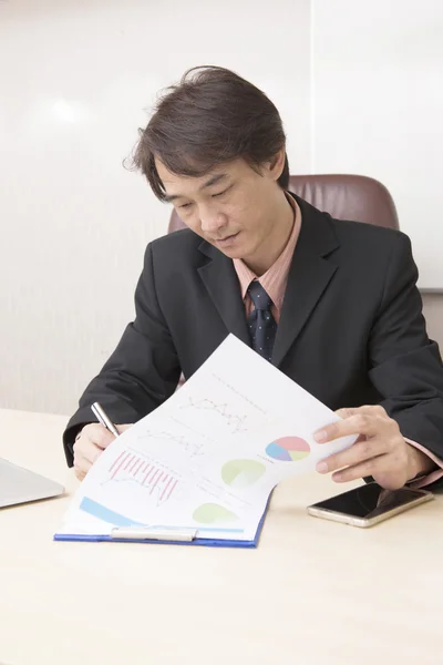 Young asian businessman working in an office. Stock Photo