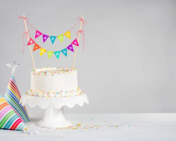 Torta di compleanno bianca bunting colorato — Foto Stock