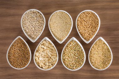 An assortment of whole grains in bowls clipart