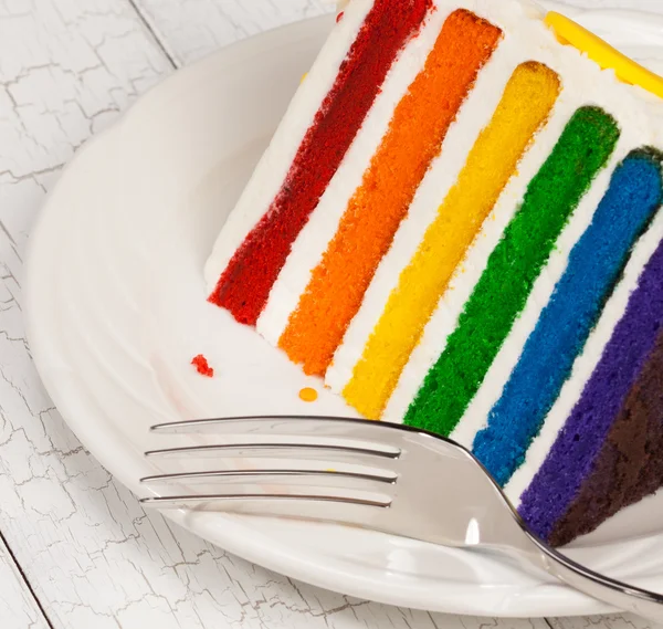 Rebanada de pastel de cumpleaños en capas de arco iris colorido —  Fotos de Stock