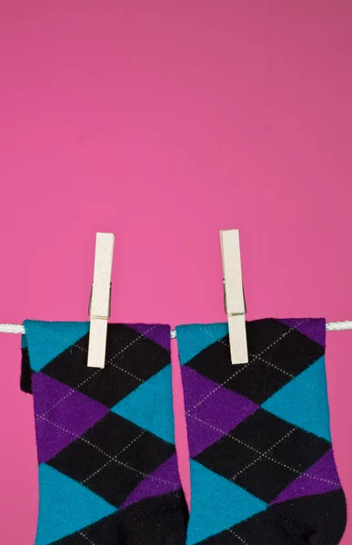 A pair of funky socks hanging on the line — Stock Photo, Image