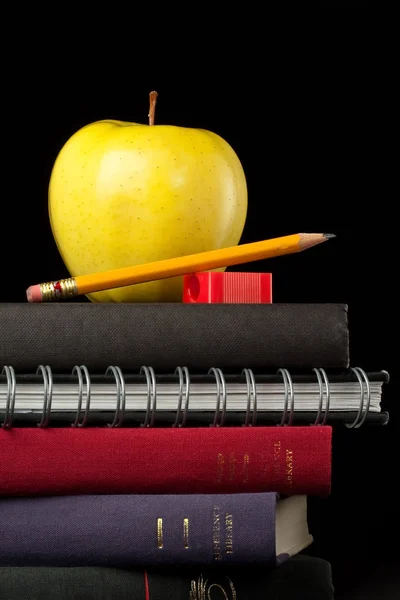 Stacked books, school supplies, and an apple — Stock Photo, Image