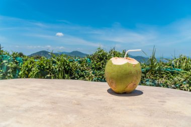 Ahşap masa mavi gökyüzü arka planda Hindistan cevizi suyu. Kopya alanı