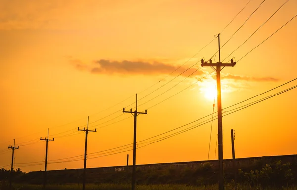 Silhouette electricity post with beautiful sunset background. — Stock Photo, Image