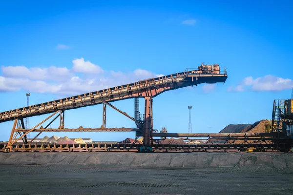 Loading iron ore conveyor machine in steel industry Stock Photo