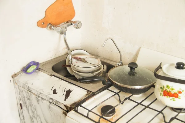 Lot of dirty dishes in the old kitchen