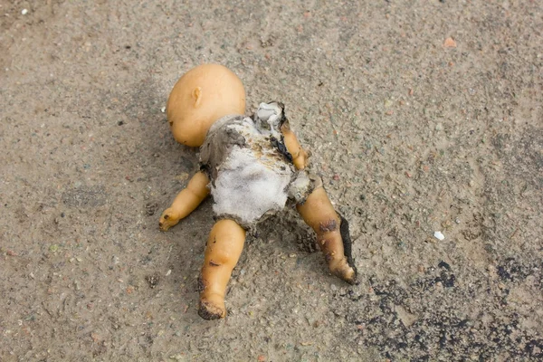 Burned old kewpie doll — Stock Photo, Image