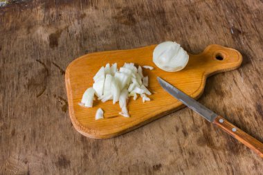 Bir ahşap tahta üzerine soğan dilimlenmiş