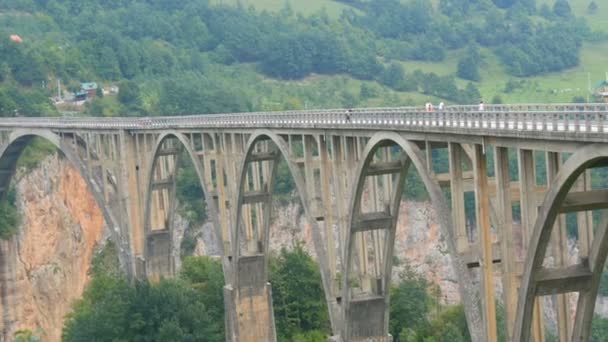 몬테네그로에 있는 유명 한 Djurdjevic 다리, 차를 몰고 가는 사람들과 관광객들은 걷는다 — 비디오