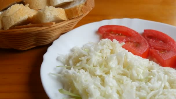 Menú vegetariano, ensalada de col y rodajas de tomate en la mesa del comedor — Vídeos de Stock