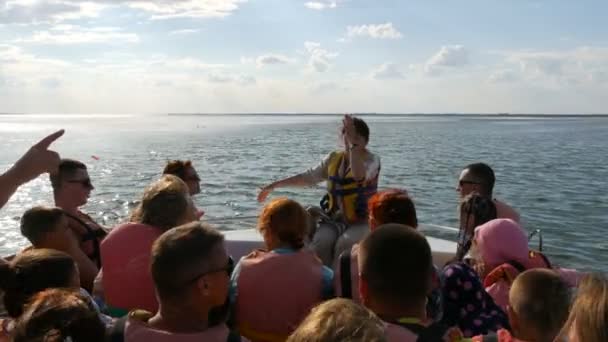 Genichesk, Ukrayna - 2 Ağustos 2020: Bir gezi teknesindeki tur rehberi can yeleği giyen turistlere hikayeler anlatır. Sivash gölü turu — Stok video