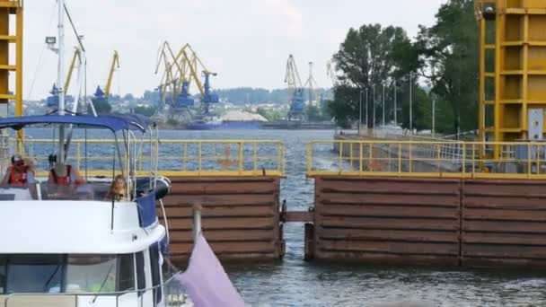 Zaporozhye, Ucrânia - 19 de junho de 2020: Descida através da fechadura da barragem dos portões da usina hidrelétrica de Zaporozhye estão fechados. O navio de cruzeiro desce do nível da água até o — Vídeo de Stock