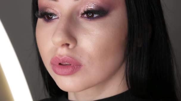 Belle jeune fille mannequin posant en studio avec soirée élégant maquillage des yeux fumés. De longs cheveux noirs et les yeux bruns vue rapprochée — Video