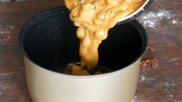 Freshly mixed dough for cherry pie poured into the bowl of multicooker for baking — Stock Video