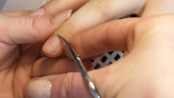 Manicure scissors trim the cuticles on the nails at home — Stock Video