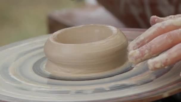 Male hands of a potter and childrens hands sculpt utensils from clay, making ceramic utensils close-up view — Stock Video