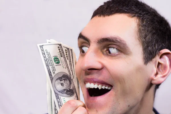 Man holding dollars and rejoices — Stock Photo, Image