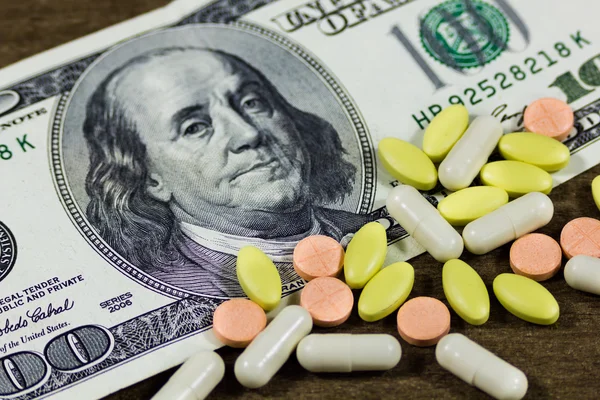One hundred dollars and pills Stock Photo