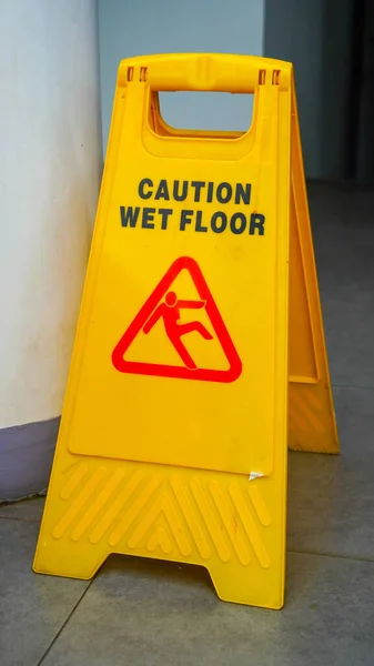 Yellow Caution Wet Floor Sign Broken Mall Floor Tiles Feet — Stock Photo, Image