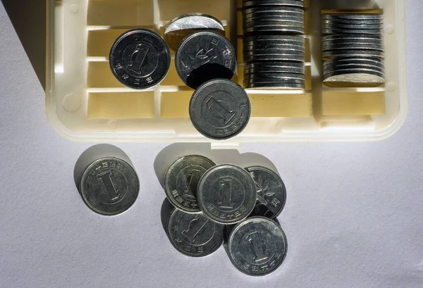One Yen on the coin box, in shallow focus. Saving money concept, cash management