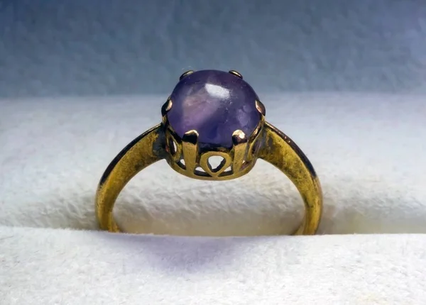 An old gold ring with amethyst in a jewelry box, selected focus