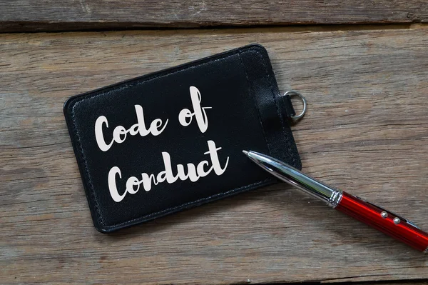 Name tag written with text CODE OF CONDUCT.