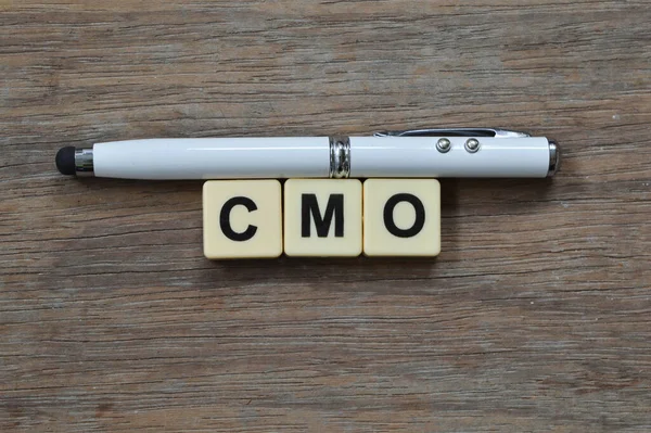 Pen and square letters with text CMO stands for CHIEF MARKETING OFFICER