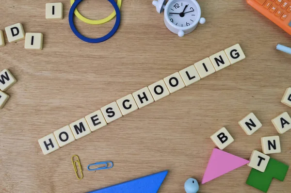 Square letters with text HOMESCHOOLING. Education concept.
