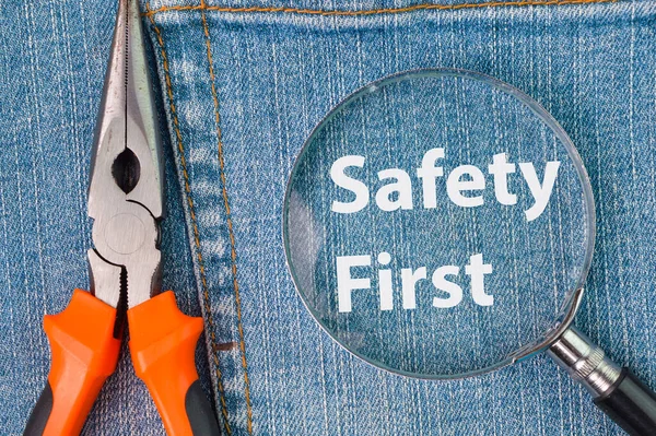 Phrase Safety First Written Magnifying Glass Pliers — Stock Photo, Image