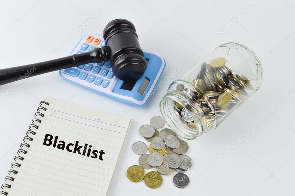 Coins, judge gavel, calculator and notebook written with BLACKLIST.