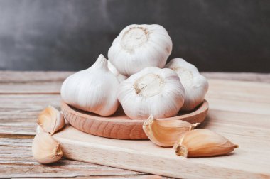 Tahta tabakta taze sarımsak. Sarımsak, soğan cinsi Allium 'un bir türüdür. Seçici odak