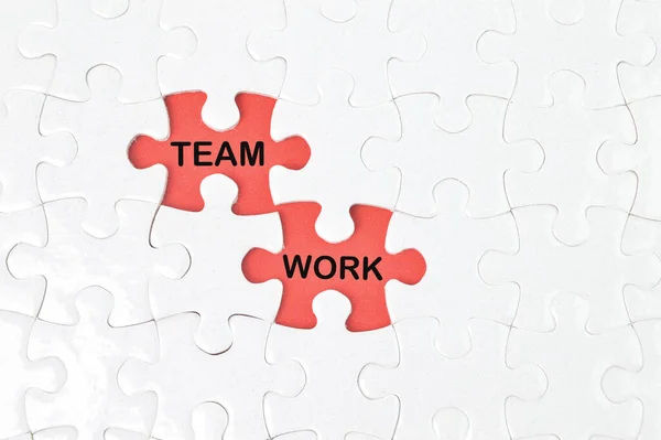 Missing jigsaw puzzle written with TEAM and WORK. Business concept.