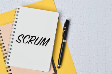 SCRUM ile yazılmış kalem ve defter üst görünümü. Kavramsal resim