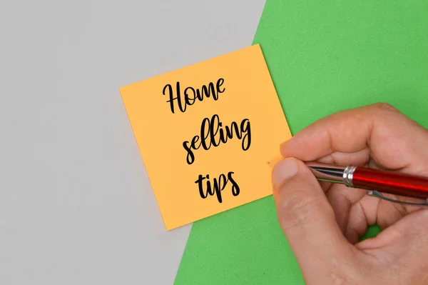 Memo note written with HOME SELLING TIPS. Business concept.