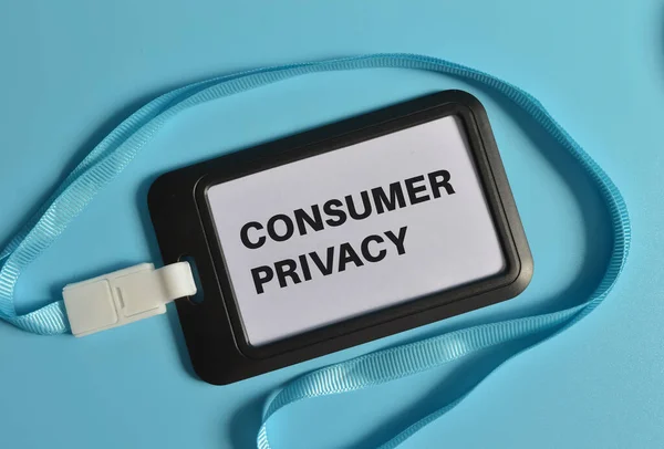 Top view of name tag written with CONSUMER PRIVACY isolated on blue background