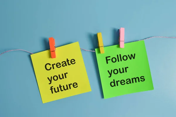 Paper notes written with CREATE YOUR FUTURE and FOLLOW YOUR DREAMS