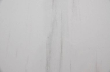 A sophisticated background featuring a smooth, white surface with subtle, smoky grey and faint brown veining, perfect for luxury and design themes.