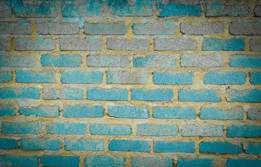 Soyulmuş turkuaz ve mavi boya desenli yıpranmış tuğla duvar