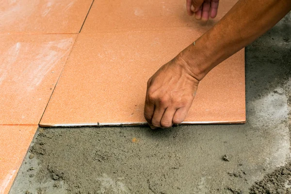 Homem trabalhador da construção é azulejos em casa, piso de azulejo adesivo r — Fotografia de Stock